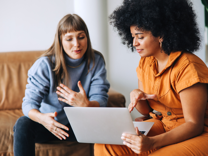 Two female entrepreneurs working as a team in a modern workplace.
