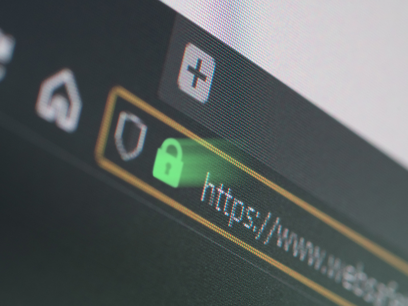 Dark web browser close-up on LCD screen with shallow focus, light shining through https padlock. Internet security, SSL certificate, cybersecurity, search engine and web browser concepts